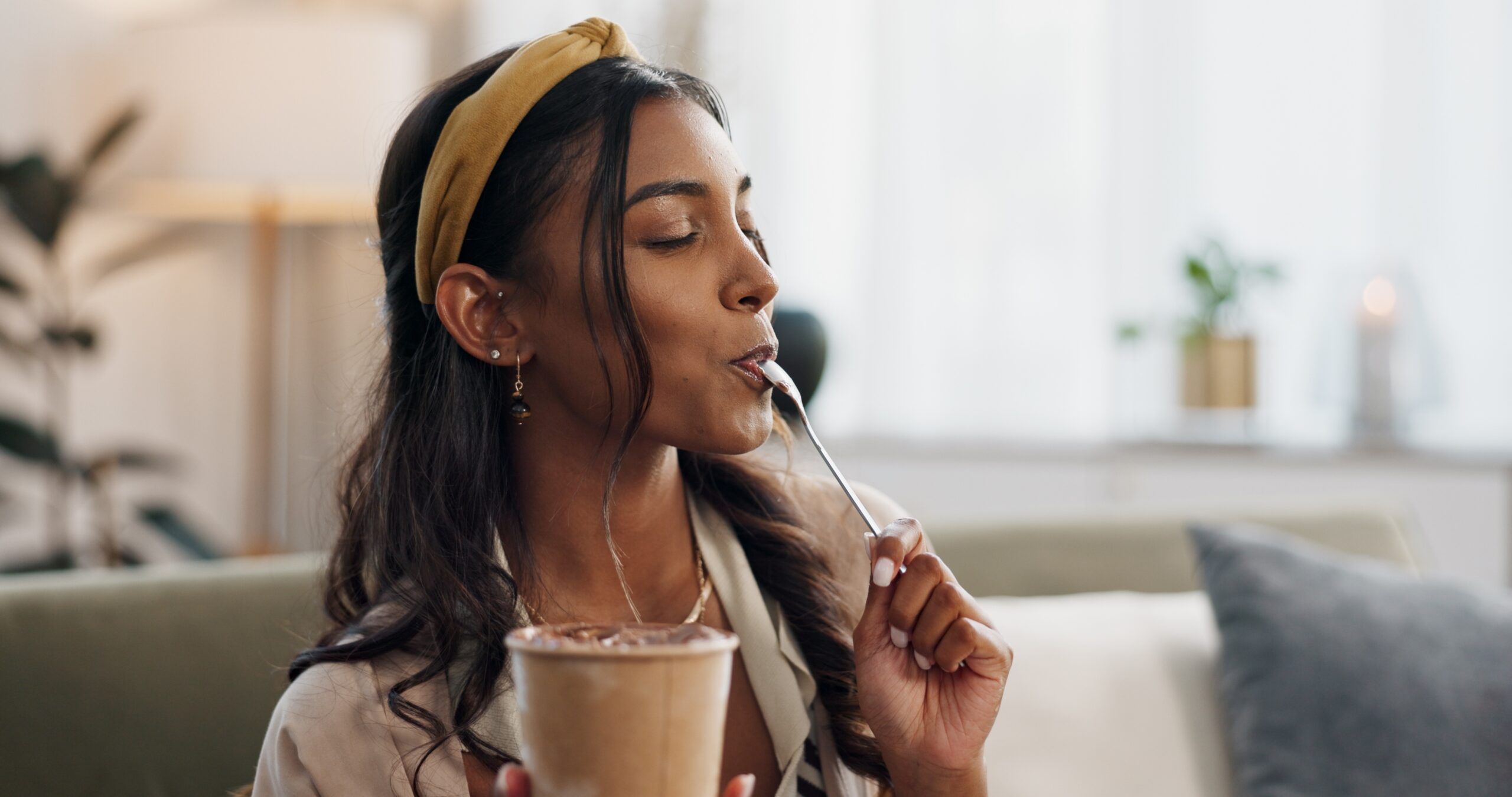 A woman savors her dessert mindfully, highlighting the importance of listening to your body’s signals.